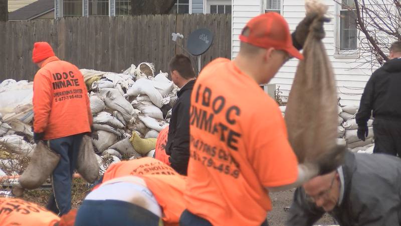 A work team with the Illinois Department of Corrections is starting to remove sandbags that...