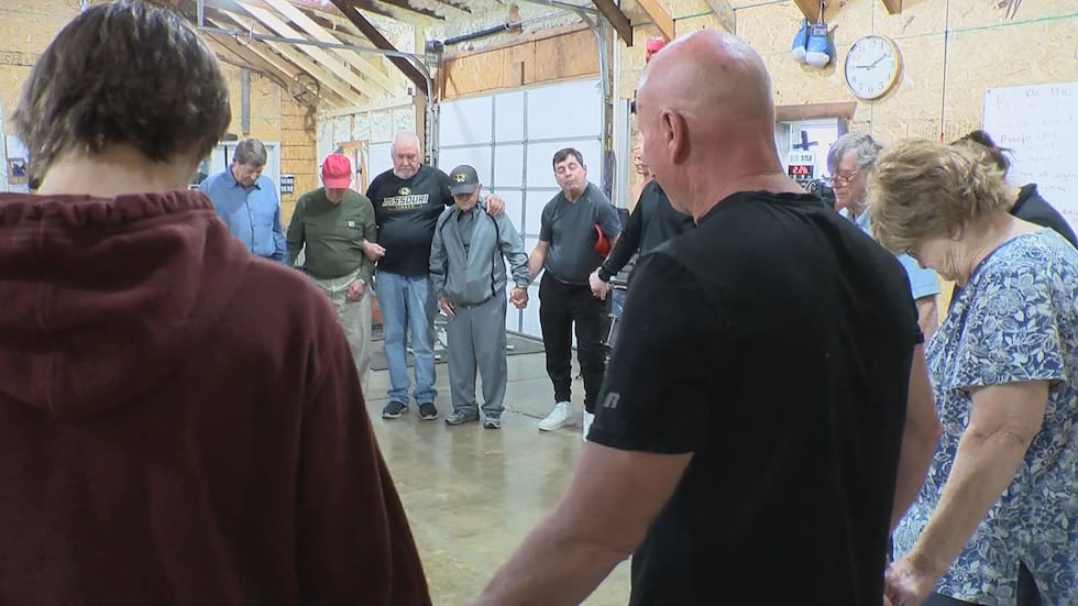 Participants gather to pray before boxing class.