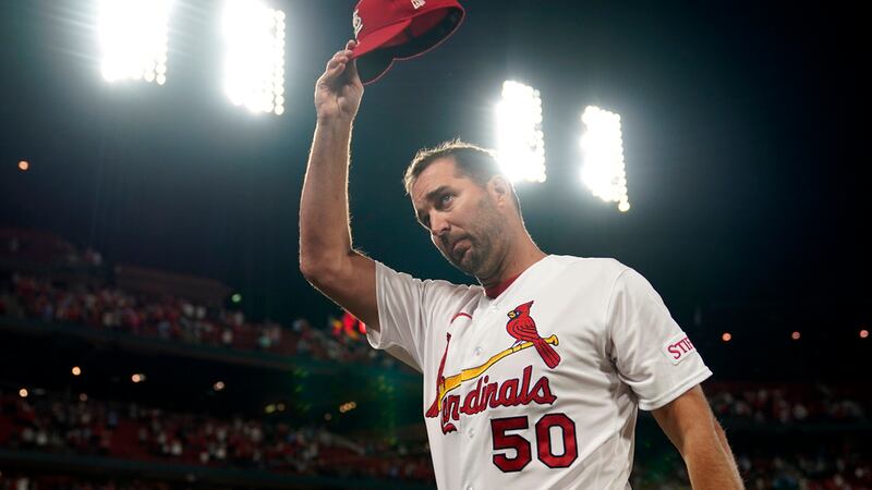 ;St. Louis Cardinals starting pitcher Adam Wainwright tips his cap after earning the win in a...