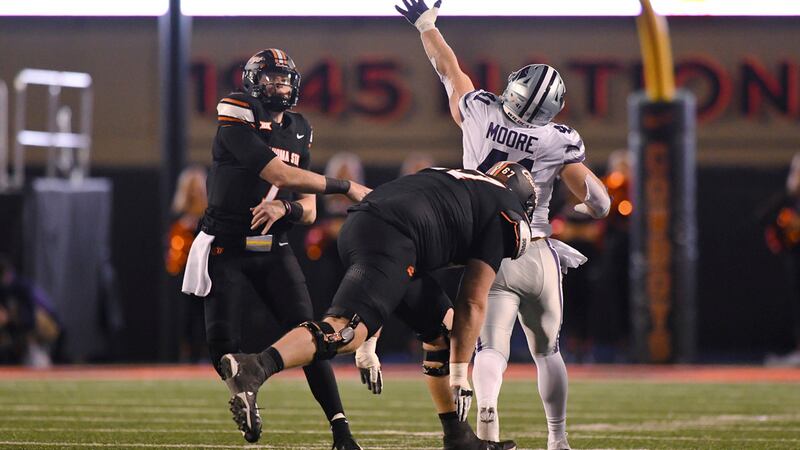Oklahoma State offensive lineman Cole Birmingham (67) runs behind Kansas State linebacker...