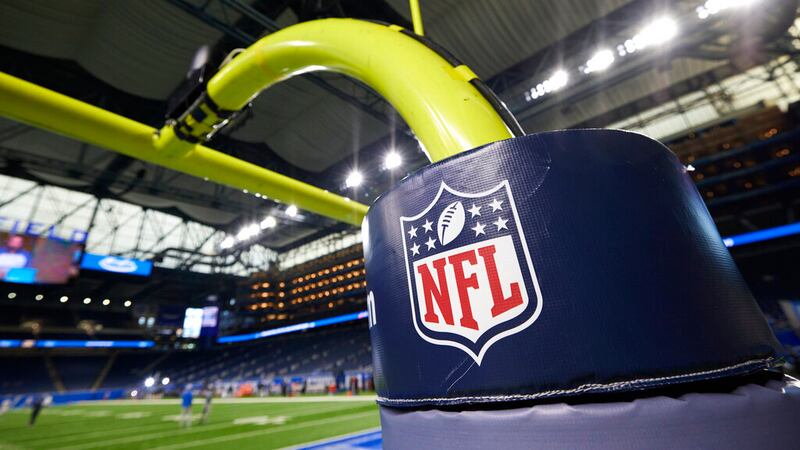 FILE - In this Aug. 13, 2021, file photo, an NFL logo is displayed on a goal post pad during...
