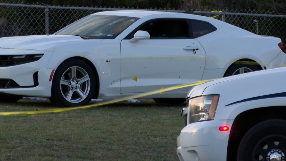 A Chevy Camaro with bullet holes in the side is shown at a cemetery in Killeen, Texas.